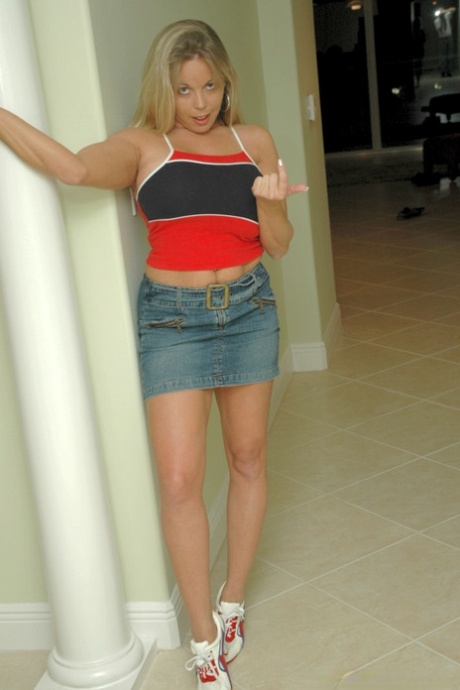 Amateur chick Amber Lynn Bach uncovers her huge boobs as she gets undressed