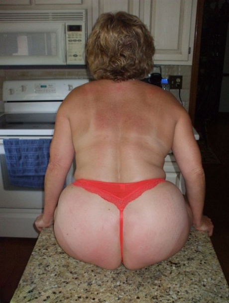 Mature woman Bustybliss flaunts her large boobs in thong underwear
