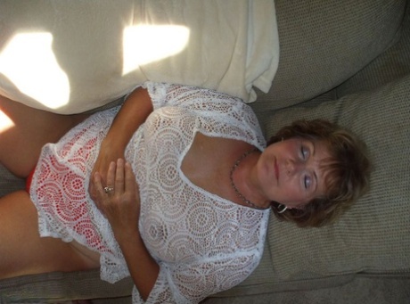Mature woman Bustybliss flaunts her large boobs in thong underwear
