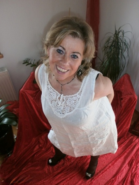 Mature blonde amateur Caro bares her natural tits and bush in stockings