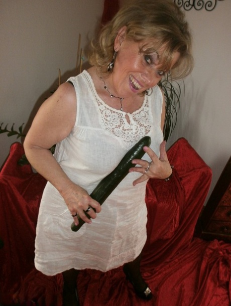 Mature blonde amateur Caro bares her natural tits and bush in stockings