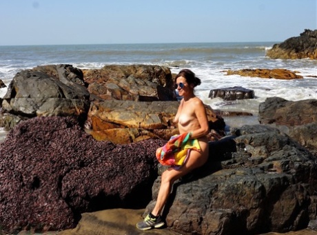 Mature amateur Diana Ananta is joined on the beach by her nudist friends