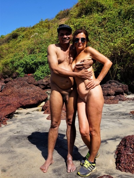 Mature amateur Diana Ananta is joined on the beach by her nudist friends