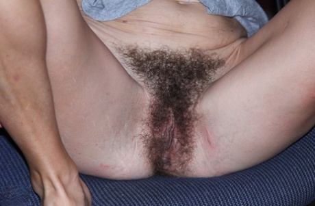 Slender woman puts her hairy pussy on display under an awning