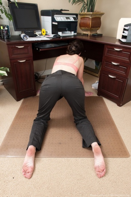 Businesswoman Veronica Snow shows off her hairy bush in her home office