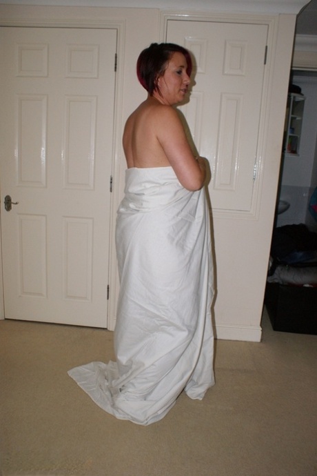 Overweight redhead models completely naked while in her bedroom