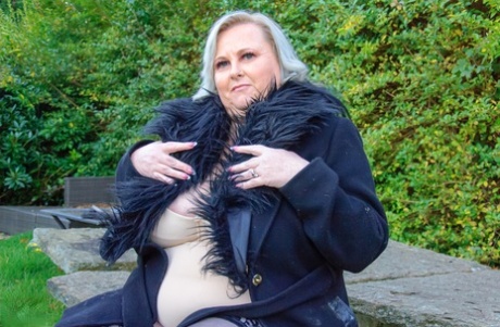 Older SSBBW masturbates on a sofa with sexual aids in stockings