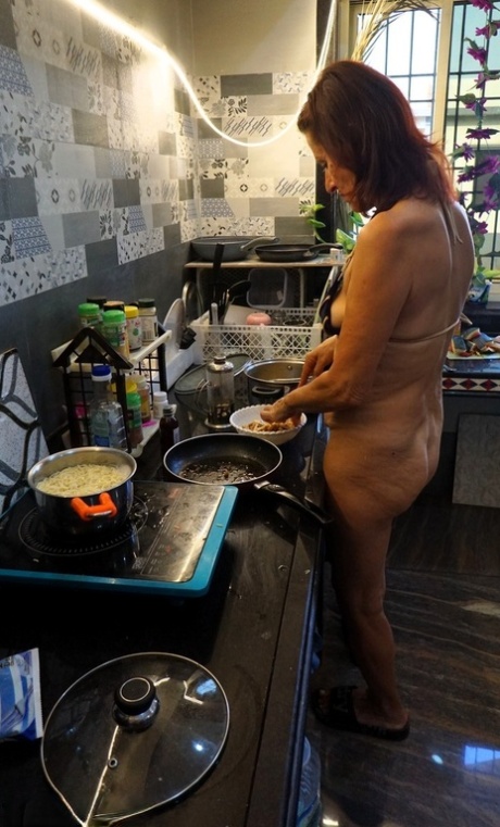 Mature lady Diana Ananta cooks up a meal while wearing a bikini