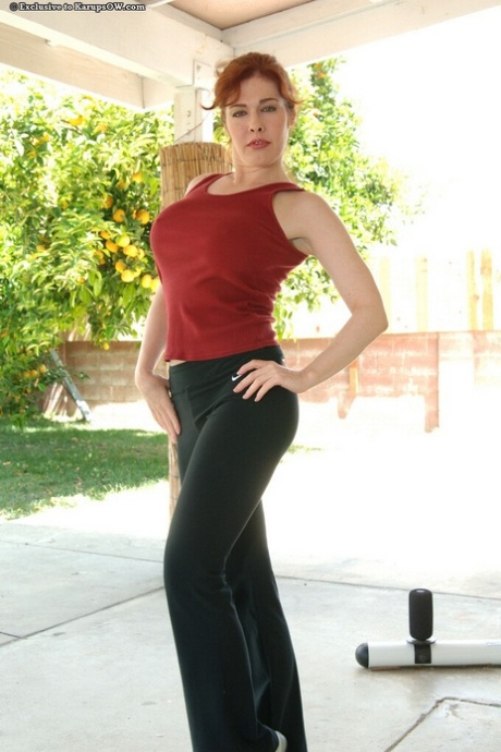 Sporty redhead mature vixen revealing her big tits and trimmed ggash