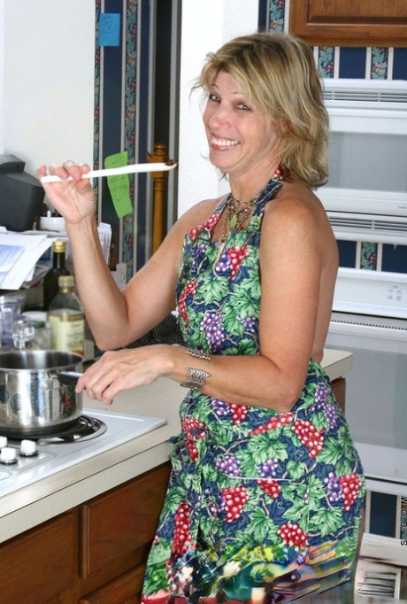Aged housewife smears chocolate on herself and sticks mixing spoon in her twat