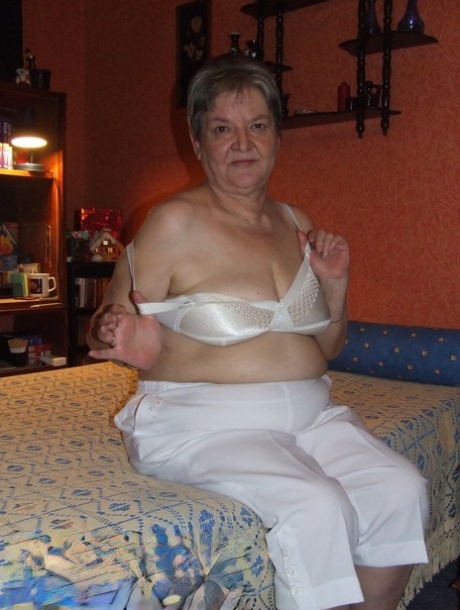 Fat granny Uschi doffs her clothes, poses naked and masturbates on a bed