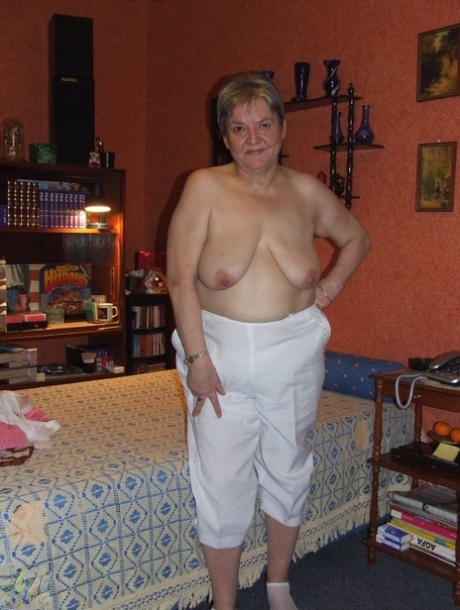 Fat granny Uschi doffs her clothes, poses naked and masturbates on a bed