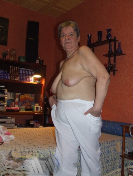 Fat granny Uschi doffs her clothes, poses naked and masturbates on a bed