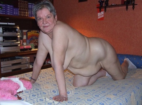 Fat granny Uschi doffs her clothes, poses naked and masturbates on a bed