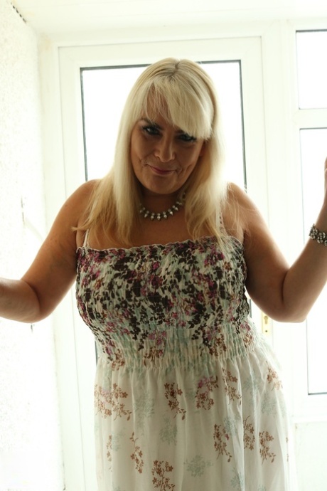 Blonde BBW Christina unleashes her big boobs and rubs her coochie