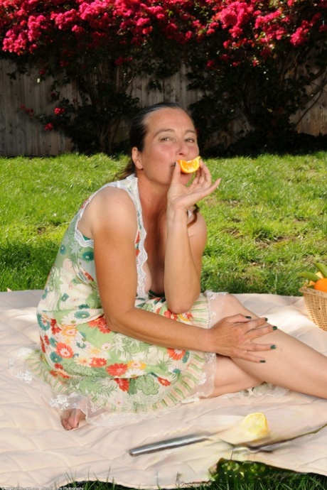 Kinky aunty Nicola shows her big juggs and flaunts her bushy beaver outdoors