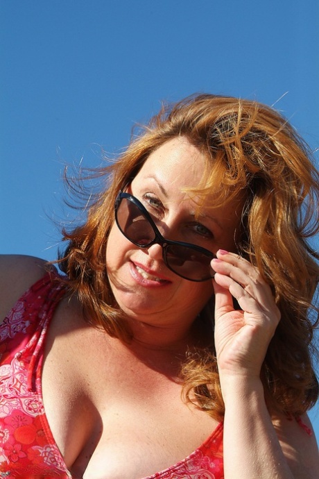 Mature amateur Marishka shows her chubby body and big tits on a tractor