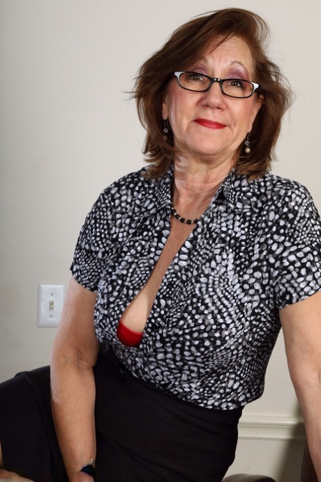Hot MILF Lynn plays with her shaved pussy after a sexy striptease