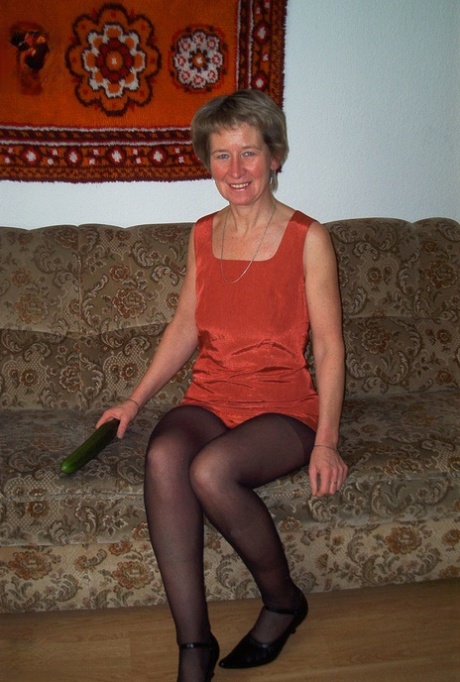 Housewife Christina toying her horny pussy with a cucumber & pissing in a bowl