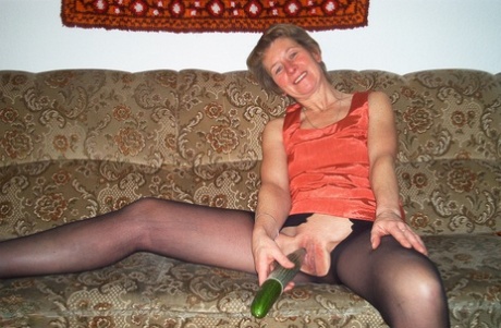 Housewife Christina toying her horny pussy with a cucumber & pissing in a bowl