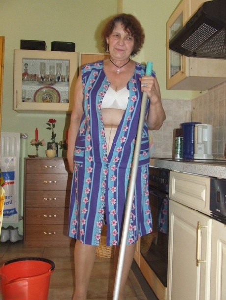 Mature BBW Marlies displays her huge tits & ass while doing housework