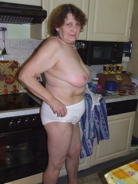 Mature BBW Marlies displays her huge tits & ass while doing housework