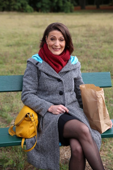 French mom Anya flashes her legs in stockings while eating a sandwich outside