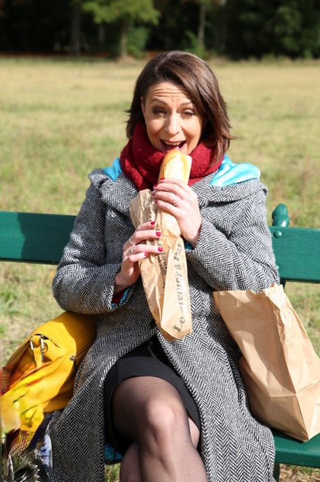 French mom Anya flashes her legs in stockings while eating a sandwich outside