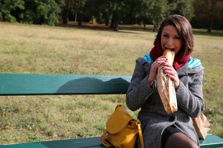 French mom Anya flashes her legs in stockings while eating a sandwich outside