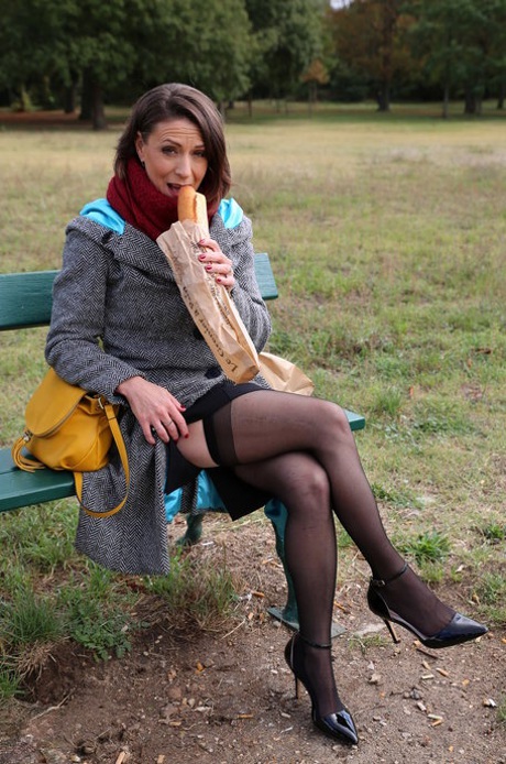 French mom Anya flashes her legs in stockings while eating a sandwich outside