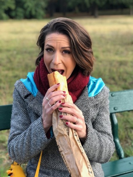 French mom Anya flashes her legs in stockings while eating a sandwich outside