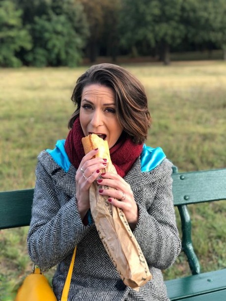 French mom Anya flashes her legs in stockings while eating a sandwich outside