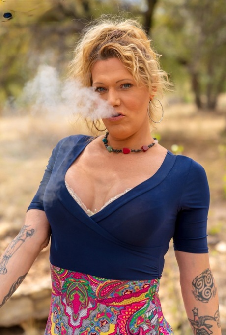 Sexy mature shemale Peggy Bambalino poses in her lingerie and toys her asshole