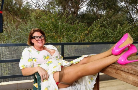 Chubby GILF in glasses Jo Jo unveils her huge tits and toys herself outdoors