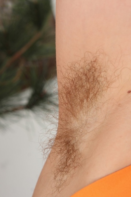 Mature wife Rosetta flaunts her hairy armpits and her twat in leather boots
